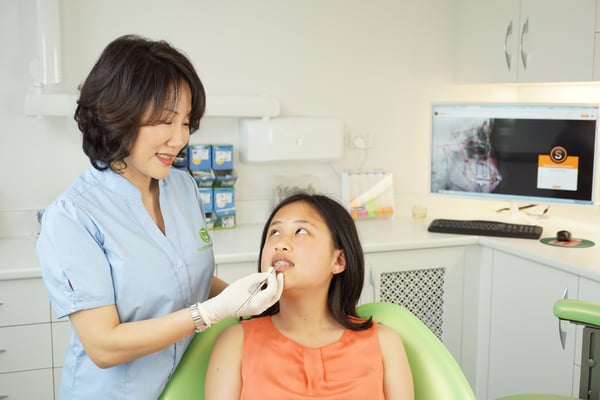 doctor treating orthodontic patient