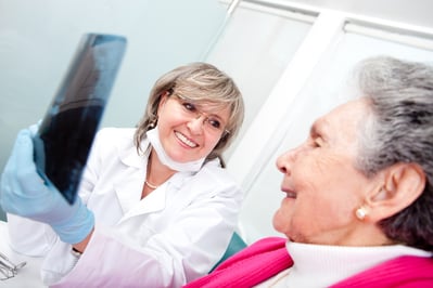 Dentist with an elder female patient looking at an x-ray.jpeg