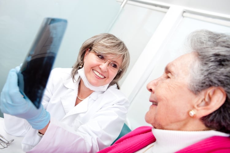 Dentist with an elder female patient looking at an x-ray.jpeg